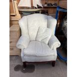 A George III style upholstered wing back library chair,