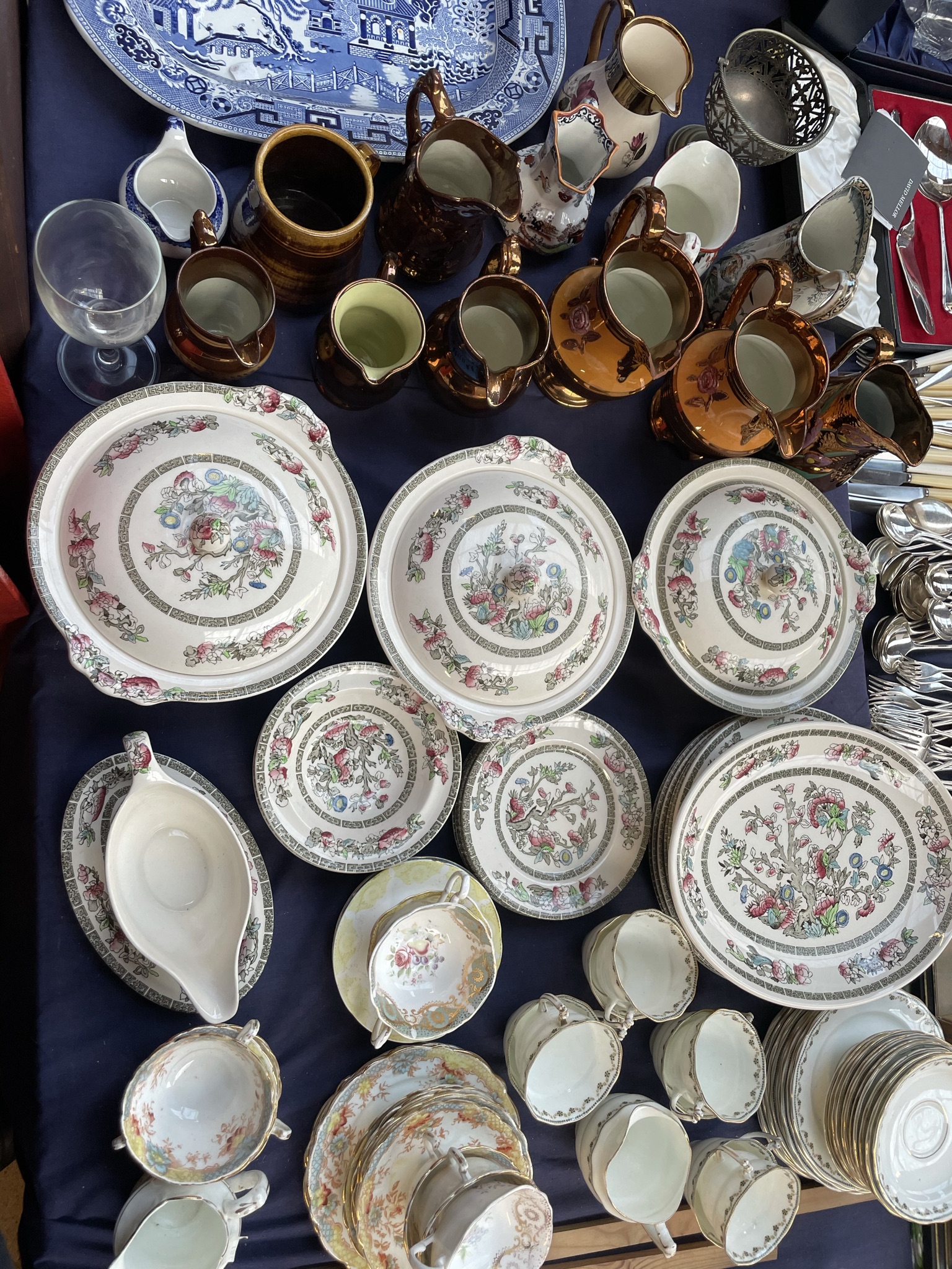 An Indian tree pattern part tea and dinner service together with copper lustre jugs,