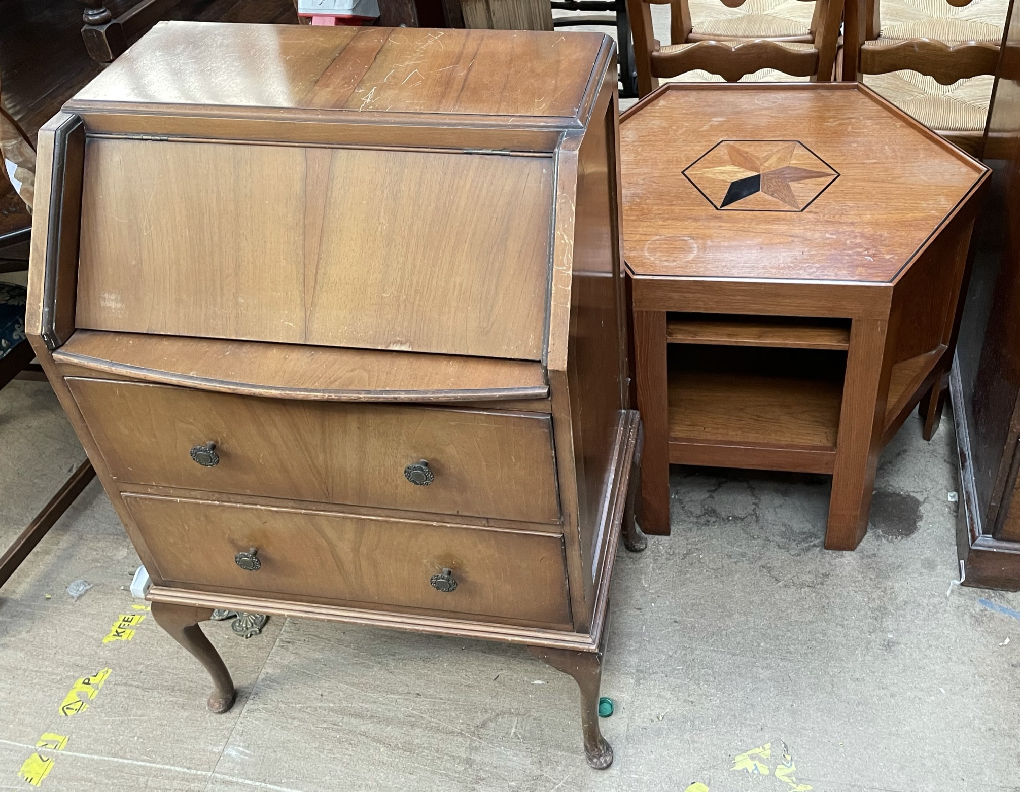 A teak bureau together with an inlaid hexagonal topped coffee table