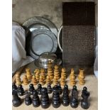 A turned chess set together with three pewter chargers,