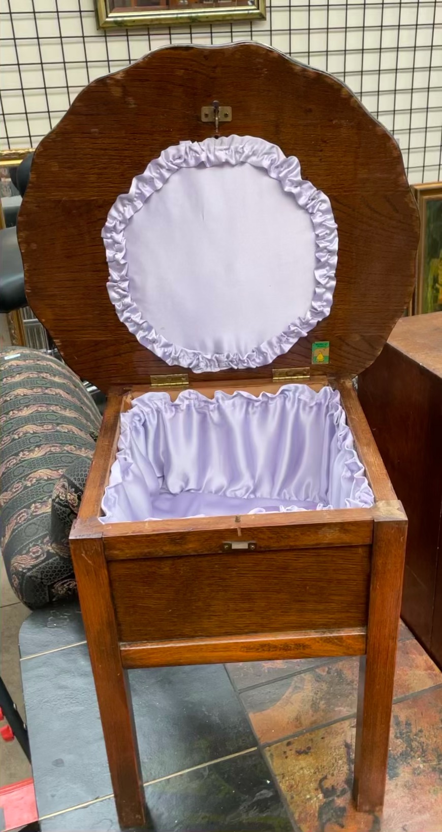 A 20th century oak sewing box with a shaped top on four square legs