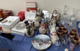 A Lladro figure of a seated boy together with glass decanters, drinking glasses, collectors plates,