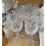 A suite of crystal wine glasses together with a decanter,