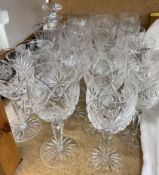 A suite of crystal wine glasses together with a decanter,