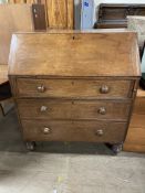 A 19th century oak bureau, the sloping fall enclosing a fitted interior of pigeon holes and drawers,