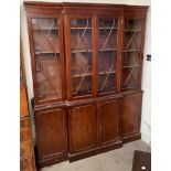 A reproduction mahogany breakfront bookcase, the with a moulded cornice above three astragal doors,