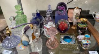 Assorted glass paperweights together with glass scent bottles,