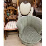 An Edwardian mahogany elbow chair with an upholstered shield shaped upholstered back,