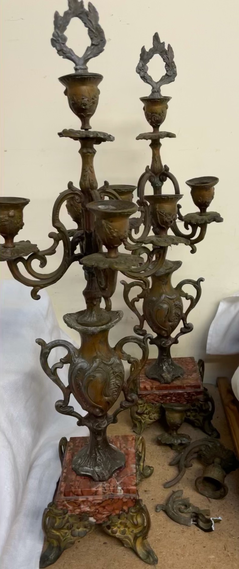 A pair of spelter candelabra on variegated marble bases