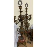 A pair of spelter candelabra on variegated marble bases