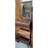 An Edwardian walnut gentleman's washstand, with a rectangular mirror above a frieze drawer,