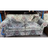 A floral decorated upholstered two seater settee