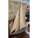 A model yacht with a canvas sail