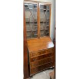 A 20th century mahogany bureau bookcase, the caddy top above a pair of glazed doors,