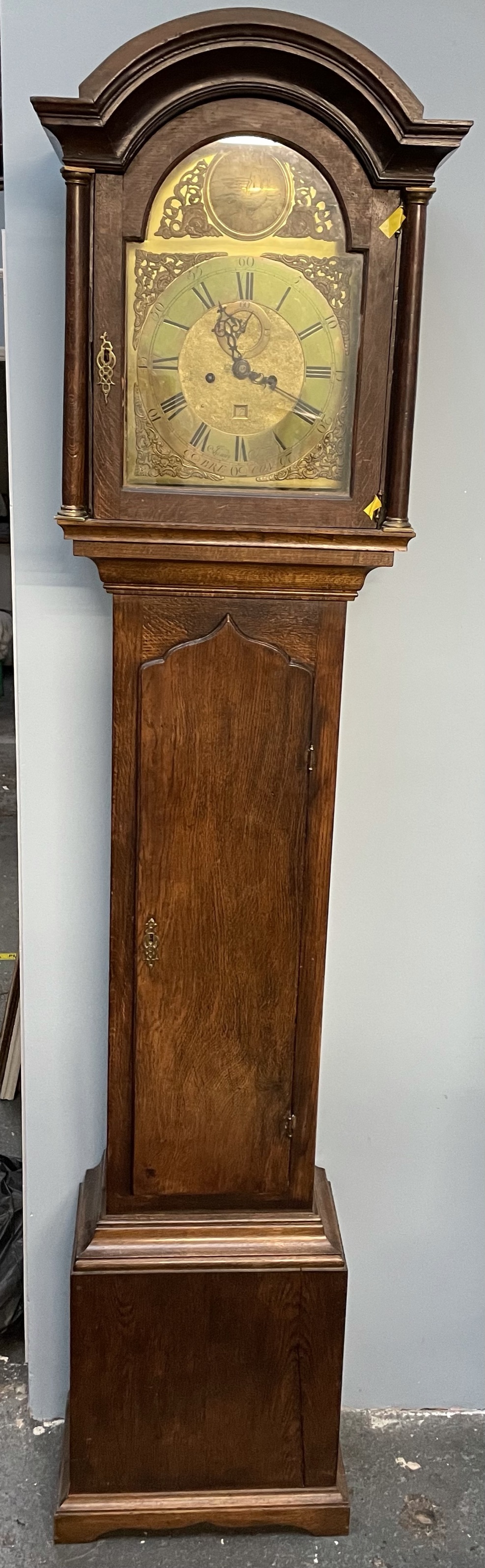 A 19th century oak longcase clock, the domed hood above a long trunk door with ogee arch,