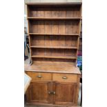 A pine kitchen dresser with a waterfall rack,