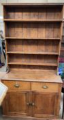 A pine kitchen dresser with a waterfall rack,