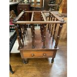 A Victorian mahogany Canterbury with three divisions above a base drawer on turned legs and casters