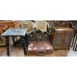 An ebonised stool the top carved with a flower head and leaves together with a smokers cabinet,