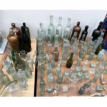 A large collection of wine bottles and other bottles