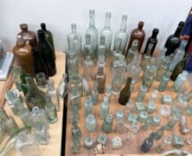 A large collection of wine bottles and other bottles