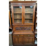 An Edwardian walnut bureau bookcase, with a moulded cornice above a pair of glazed doors,
