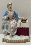 A Meissen figure of a seated lady reading,