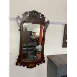 A George III style mahogany wall mirror with a phoenix surmount, the base inlaid with a shell,