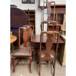 A set of four Queen Anne style dining chairs together with a rosewood effect drop leaf dining table
