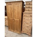 A large pine wardrobe together with a large pine chest of drawers and a pine bedside cabinet