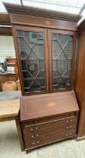 An Edwardian mahogany bureau bookcase, the moulded cornice above a pair of astragal glazed doors,