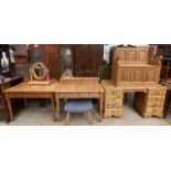 A pine box settle together with a pine desk, a pine side table, another pine desk,
