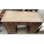 An early 20th century oak pedestal desk,