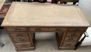 An early 20th century oak pedestal desk,