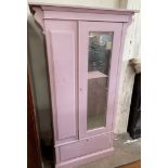 A pink painted wardrobe,
