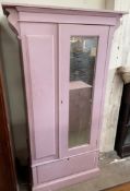 A pink painted wardrobe,