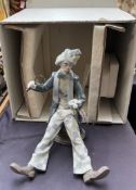 A Lladro figure of a clown "Checking the time",