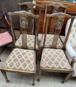 A set of four Edwardian salon chairs with a fan back and drop in seat on square tapering legs