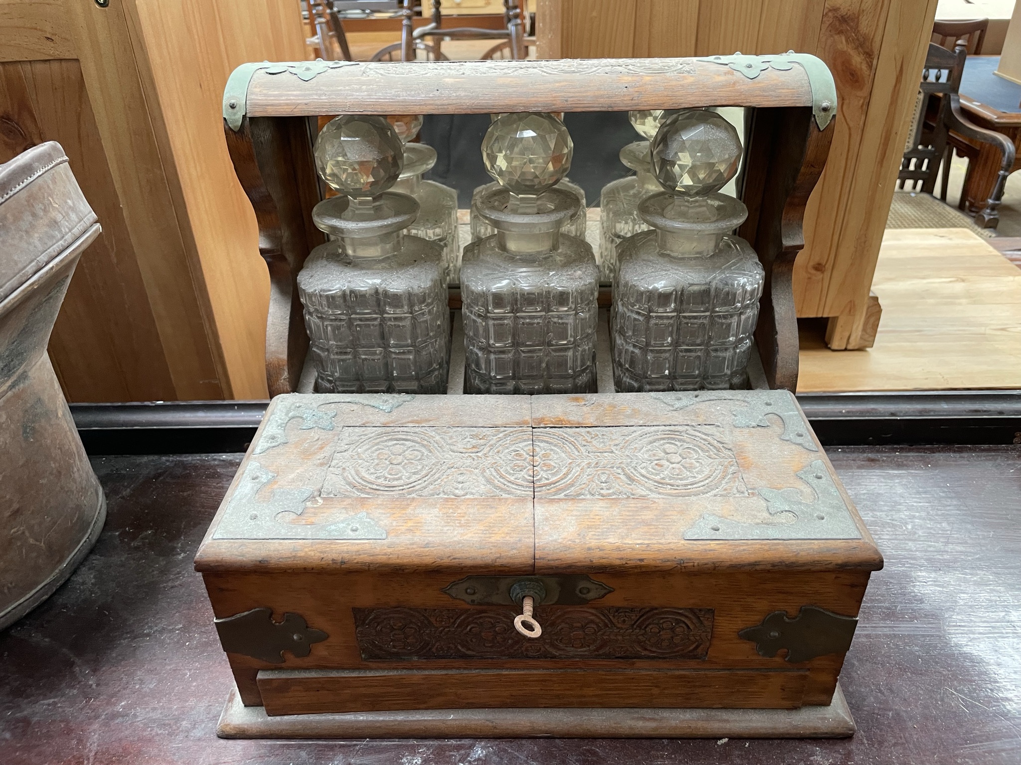 An oak cased three decanter tantalus,