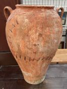 A large twin handled floor standing olive pot