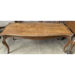 A French Kingwood coffee table with a shaped parquetry top on cabriole legs with gilt metal mounts