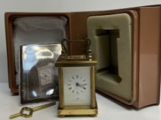 A Matthew Norman miniature brass cased carriage time piece, with a white dial and Roman numerals,