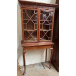 A 20th century oak bookcase with a moulded dentil cornice and a pair of Astragal glazed doors,