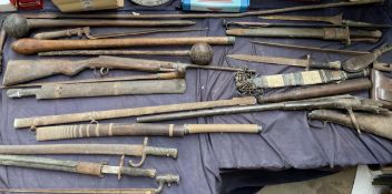 Assorted bayonets, spears, clubs, daggers,