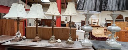 A pair of brass table lamps together with two other pairs of table lamps