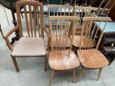 A set of four Ercol Beech stick back and elm seated dining chairs together with another chair