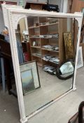 A large cream painted overmantle mirror