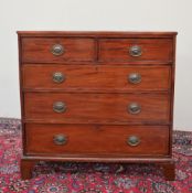 A George III mahogany chest of drawers with two short and three long drawers on bracket feet,