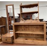 A pine bookcase together with a pine hanging shelves and a pine cheval mirror