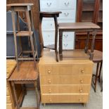 An oak chest of drawers together with a pine table,